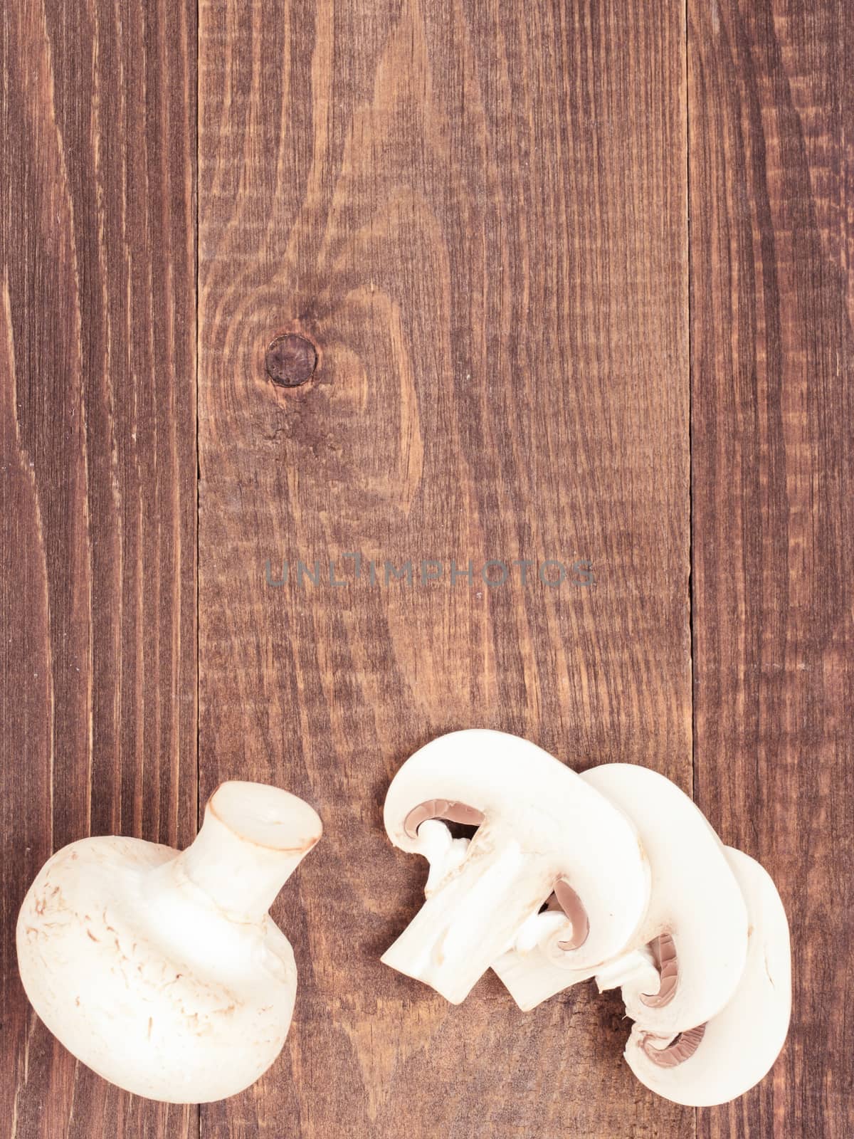Fresh white champignon mushrooms close up on wooden background by fascinadora