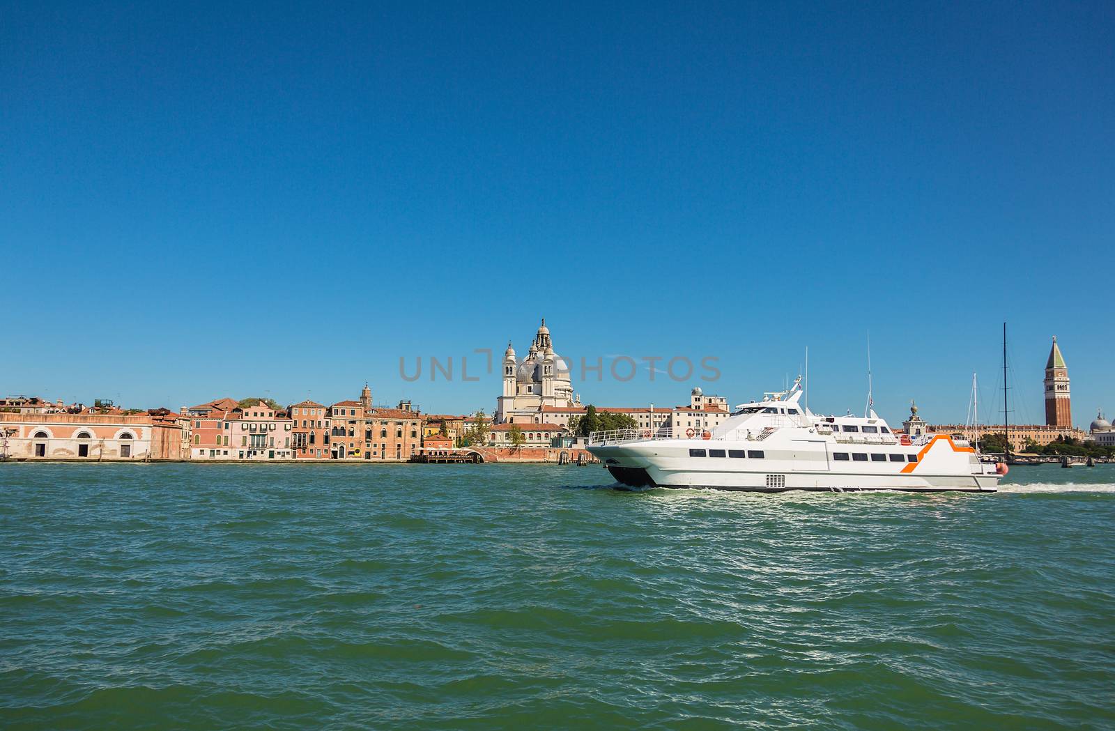 VENICE, ITALY - AUGUST 7 2016: Boat floating from the island of San Giorgio, Venice, Italy