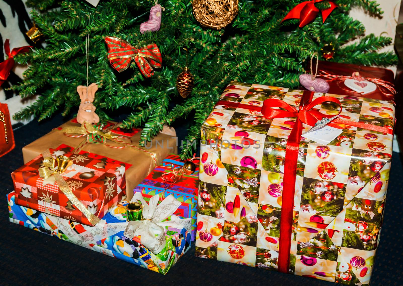 dressed up under the Christmas tree are boxes with gifts.