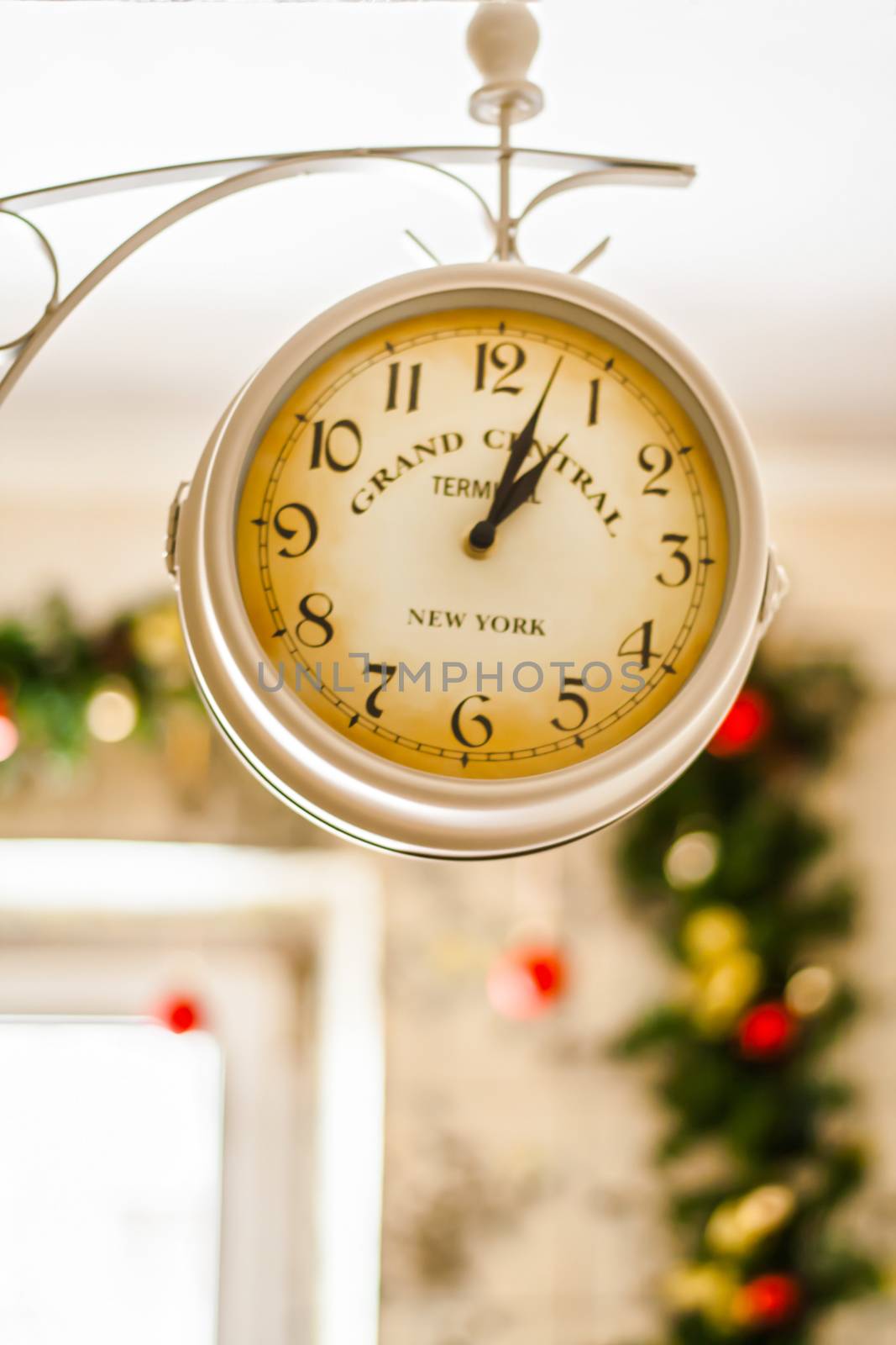 antique clock on the background of Christmas garlands.