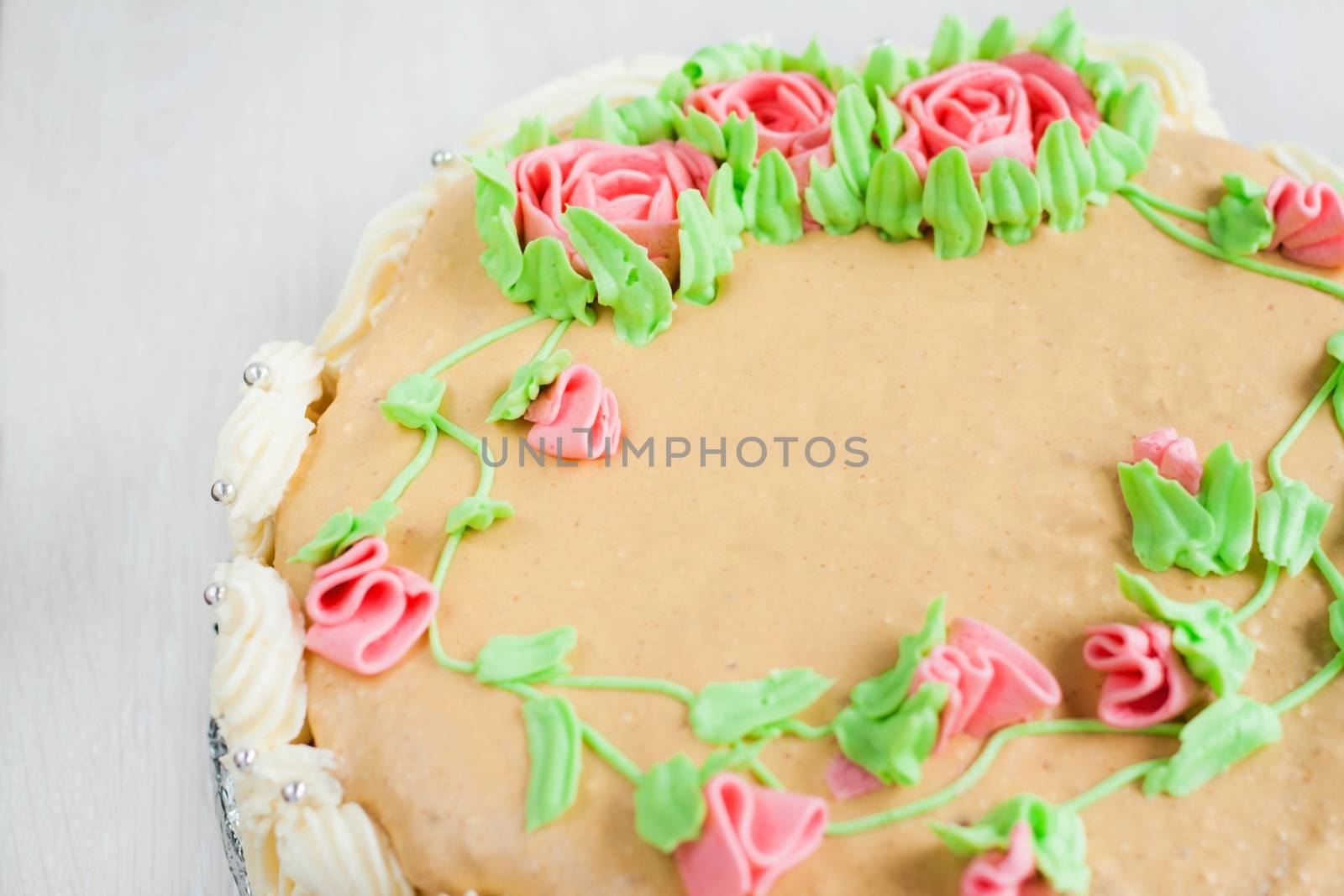 birthday cake decorated with roses, leaves, swirls and the inscription, Catherine Day