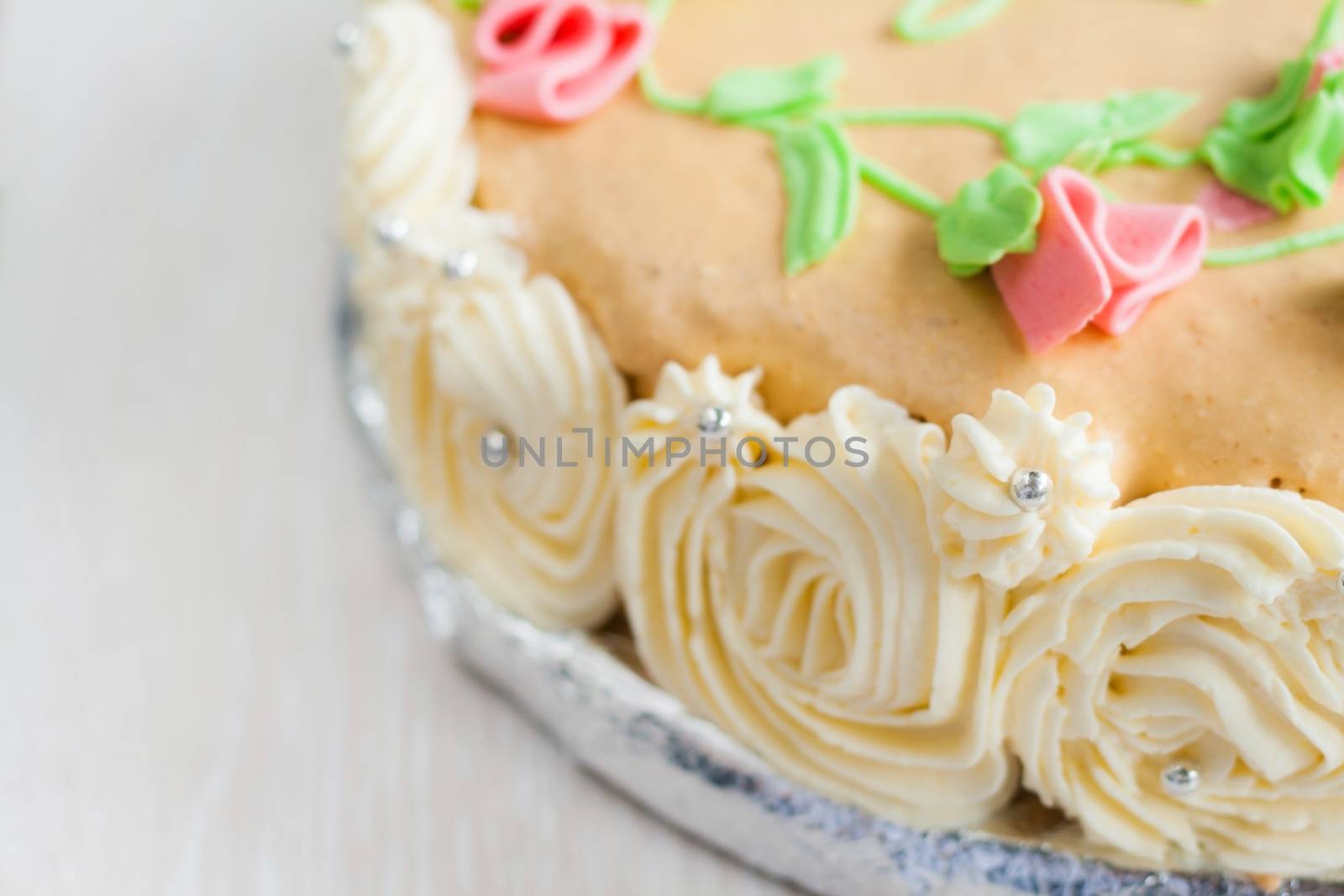 birthday cake decorated with roses, leaves, swirls and the inscription, Catherine Day
