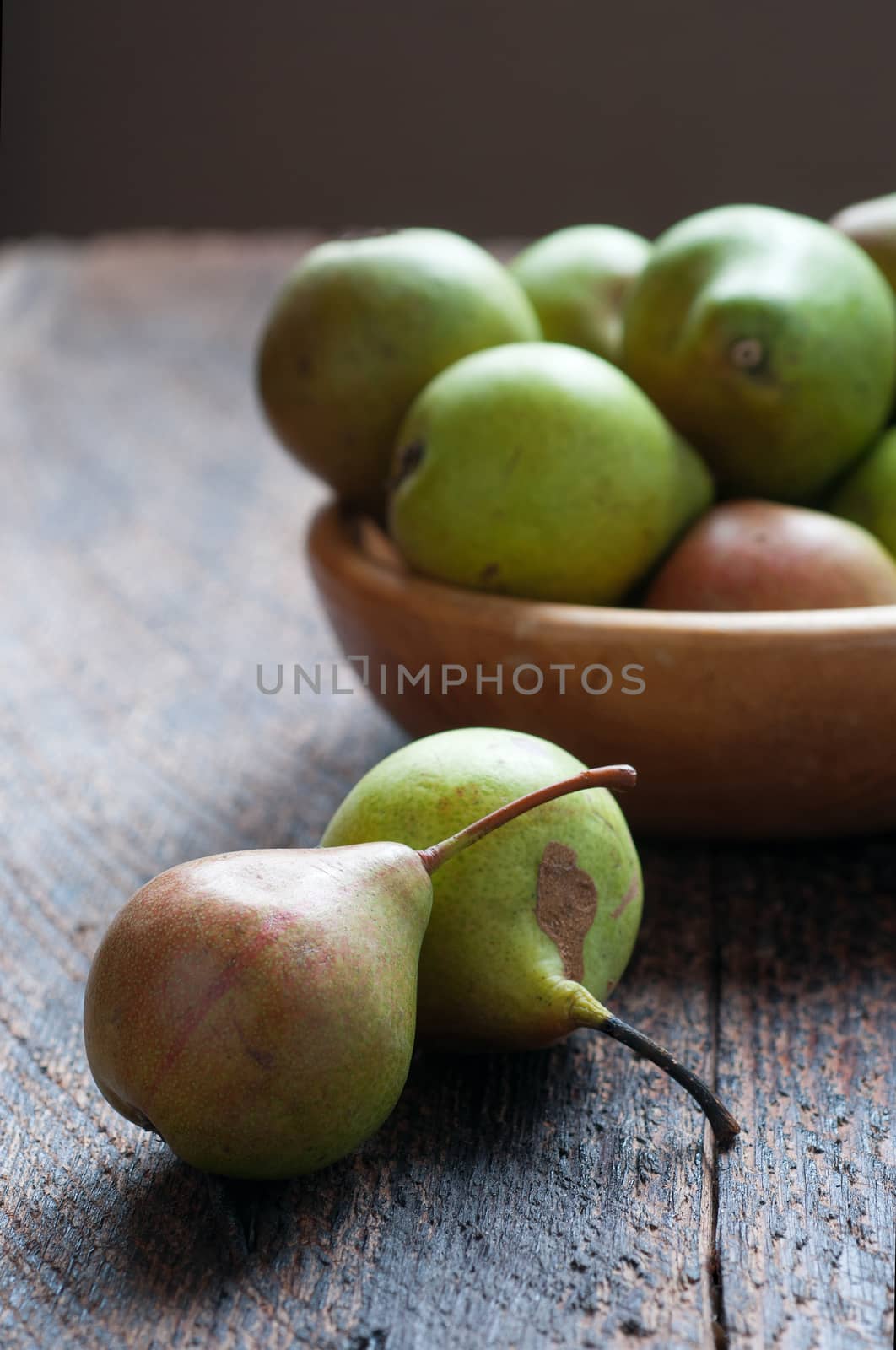 Green Pears in Wooden Plate On The Table