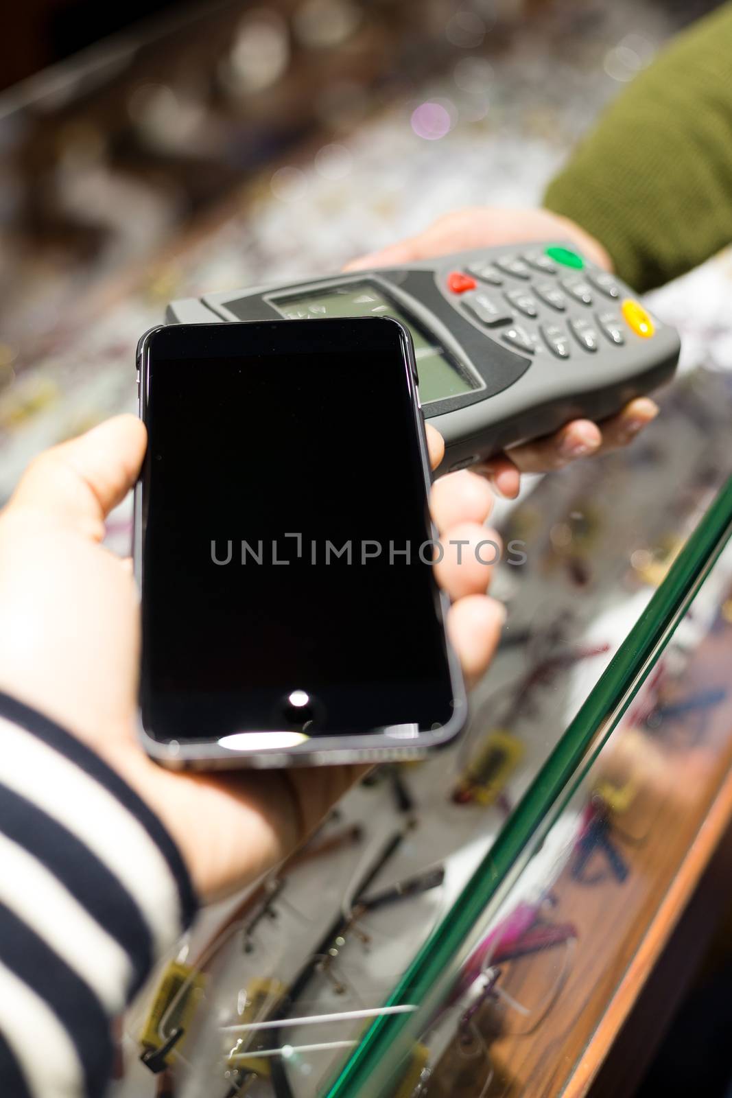 Woman pay with mobile phone by NFC by leungchopan