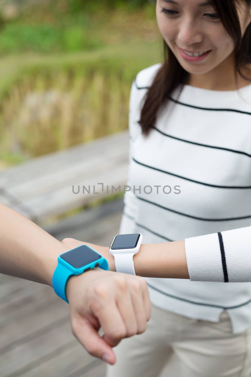Two people connecting smartwatch together