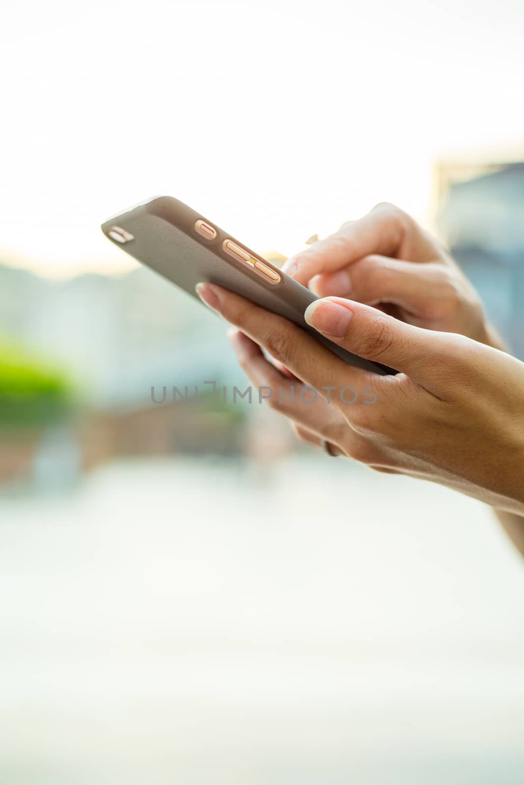 Woman sending sms on mobile phone
