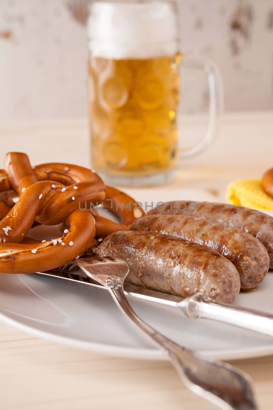 Closeup of bavarian cooked sausage and pretzel by LuigiMorbidelli