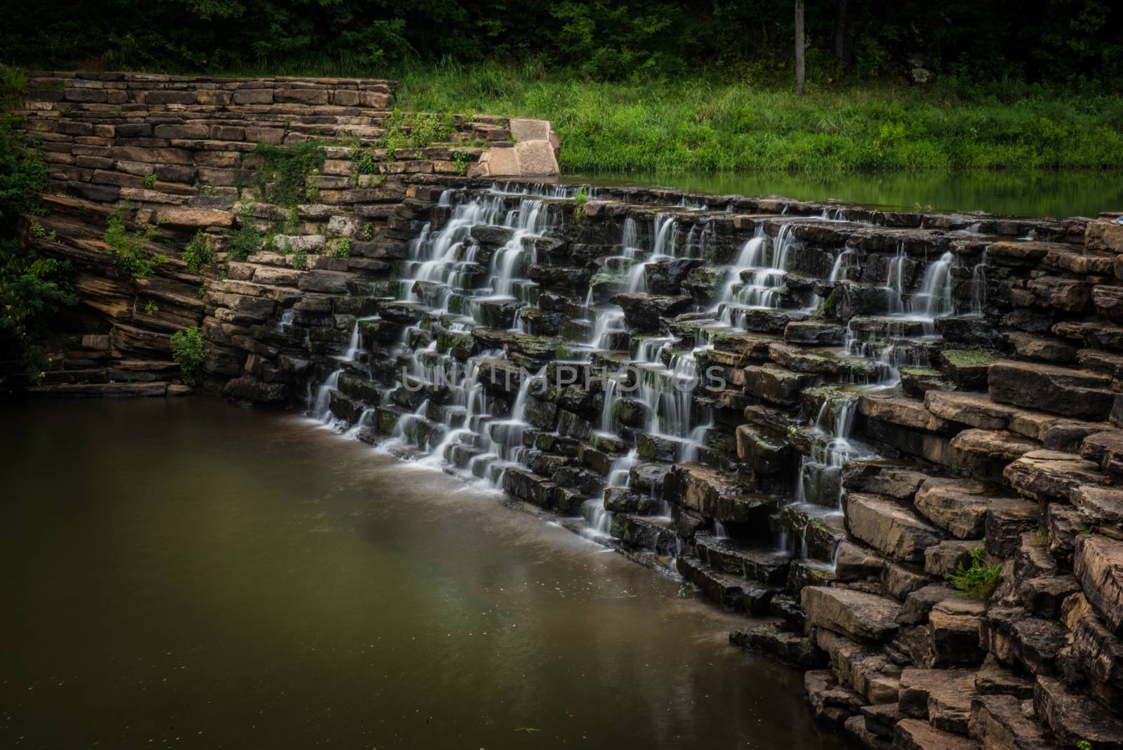 Image of water flowing over a man made waterfall