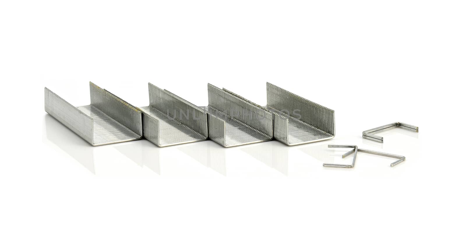 Stack of metal staples on a white background