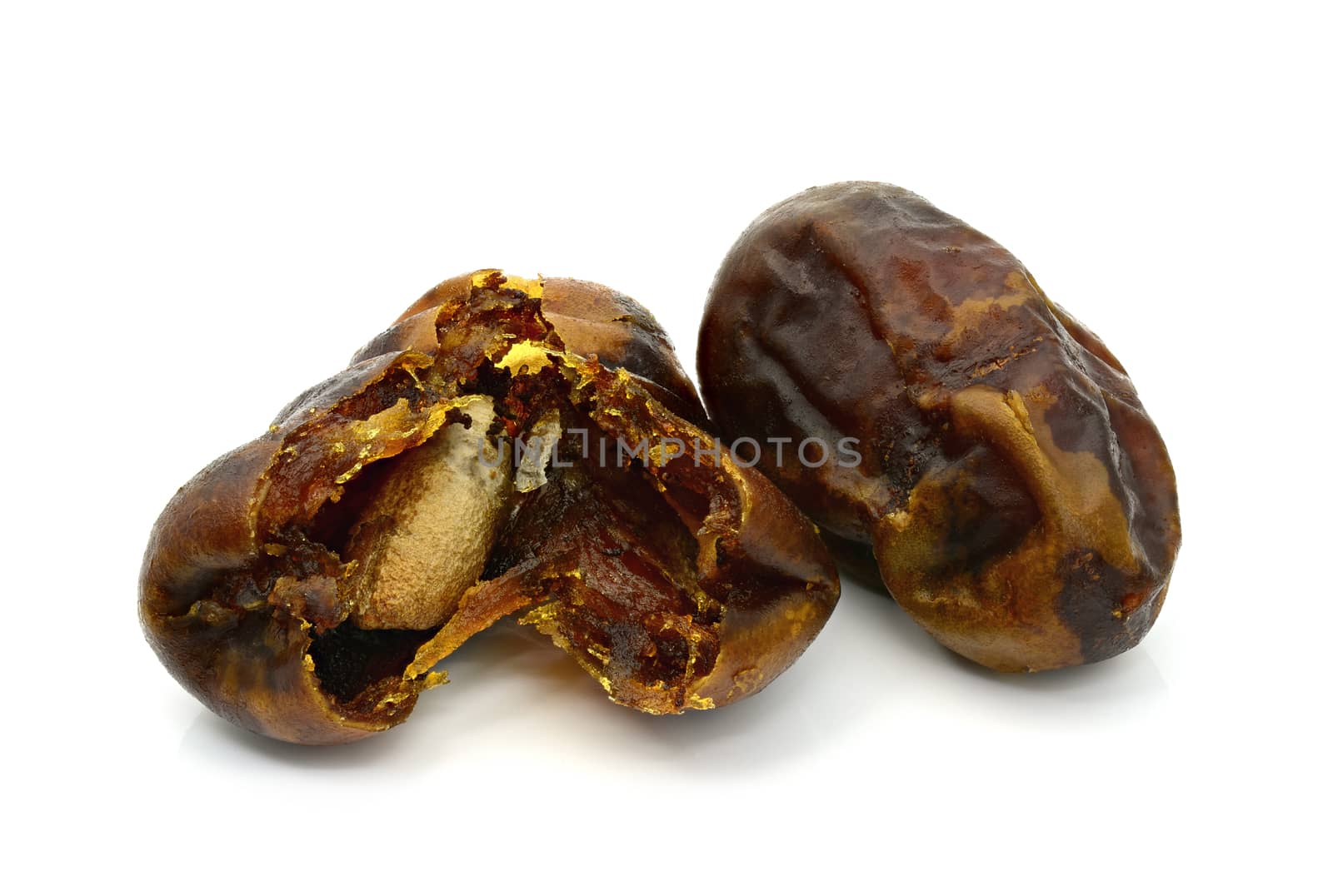 Dry date palm fruit on a white background