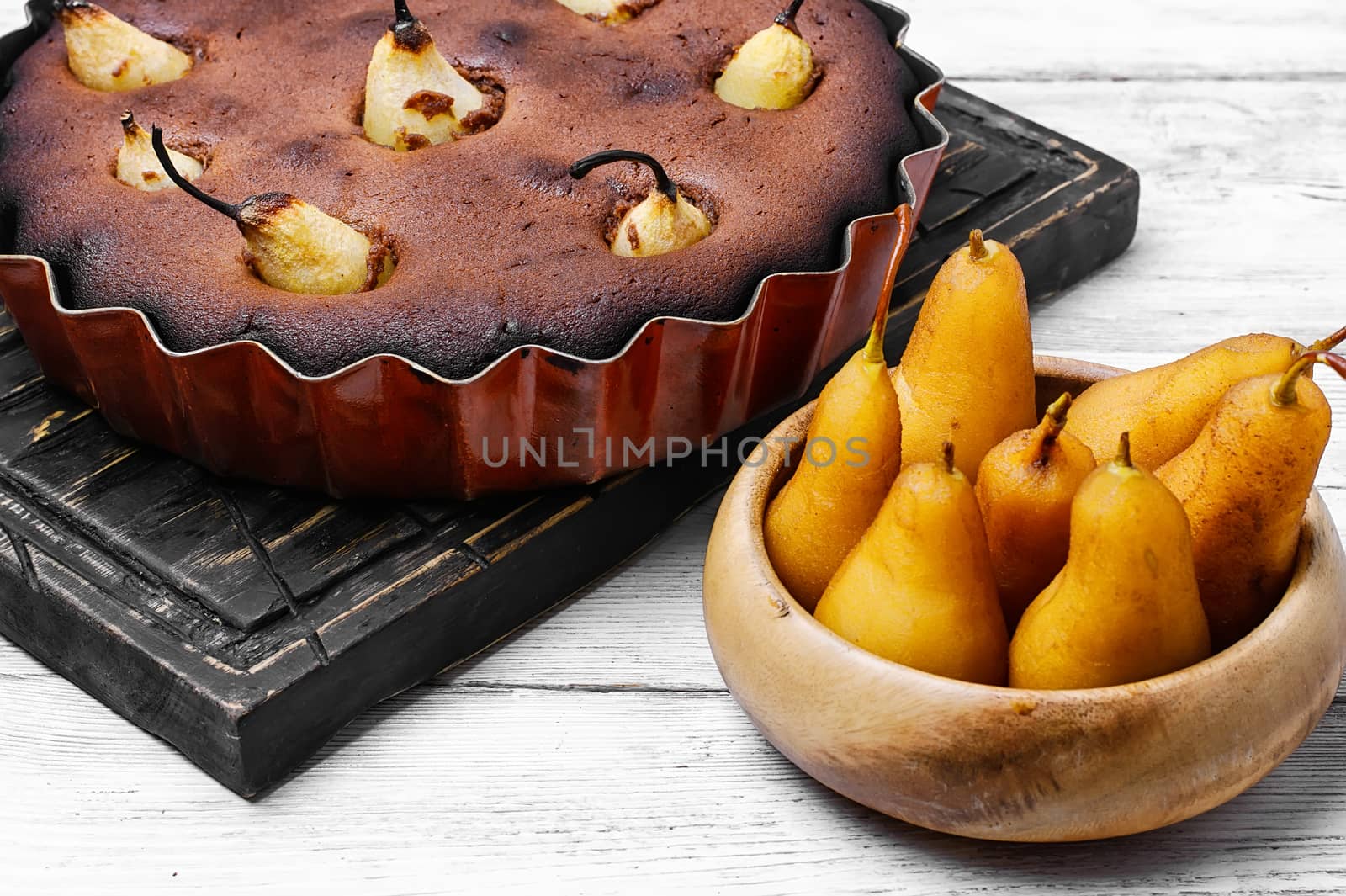 Baked sweet cake with whole pears in baking dish