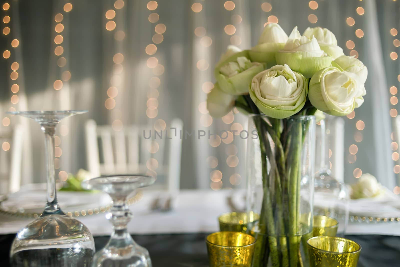 Elegance table set up with lotus flowers, selective focus.