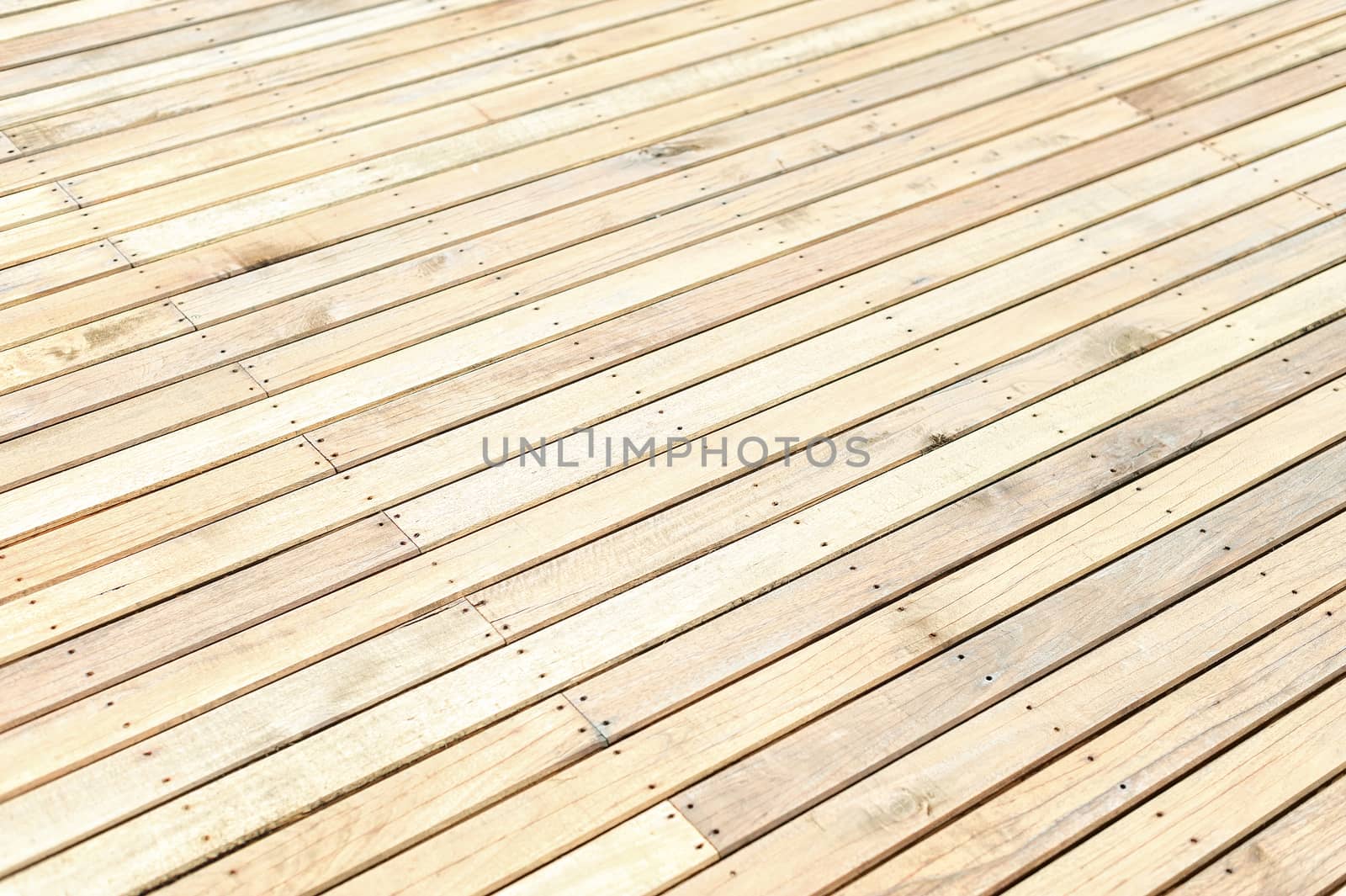 Unfinished new wooden floor at a construction site. Abstract background with copy space. Shallow depth of field. 