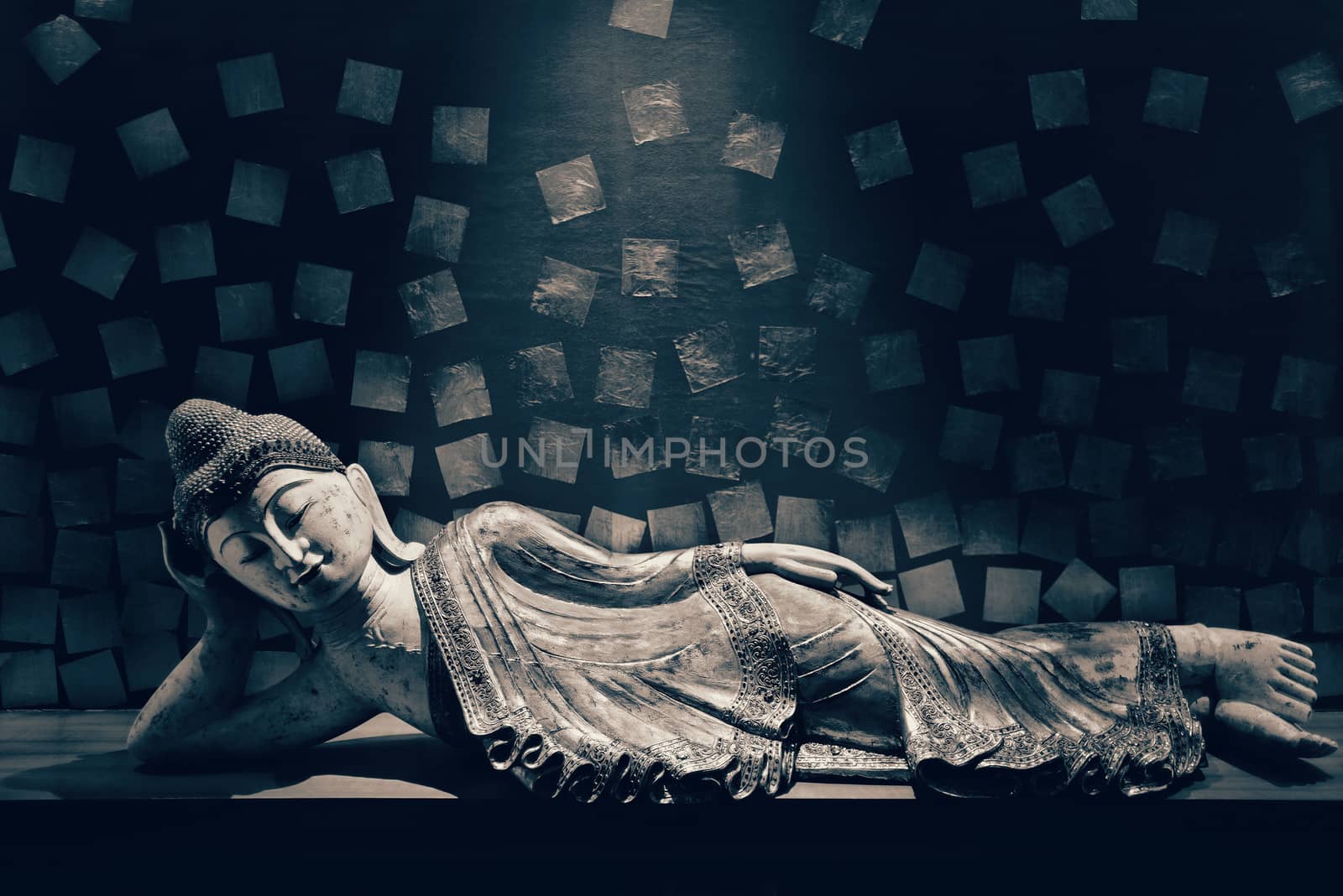 Antique carved wooden Buddha, reclining Buddha posture. selective focus.