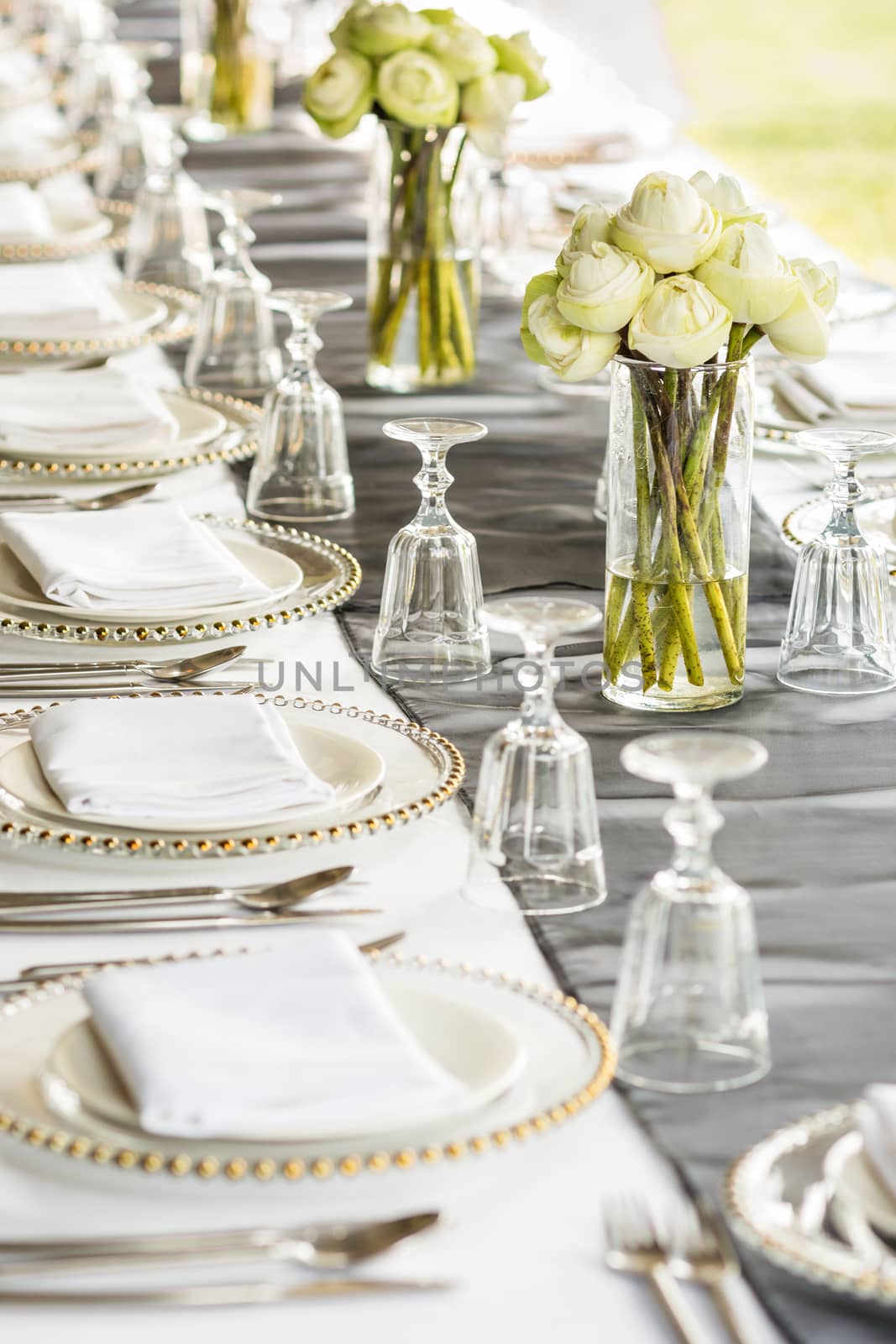 Elegance table set up with lotus flowers, selective focus.