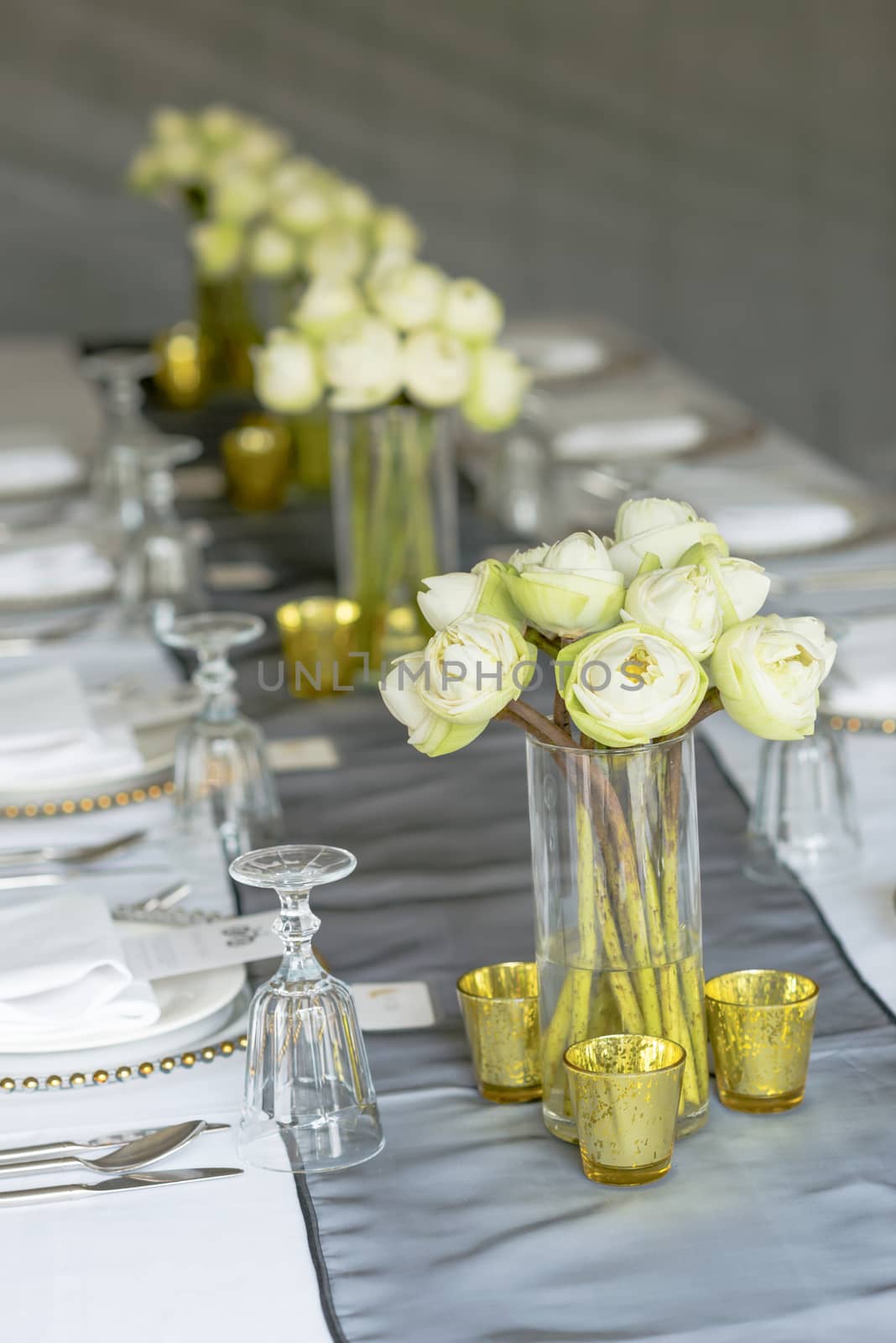 Elegance table set up with lotus flowers, selective focus.