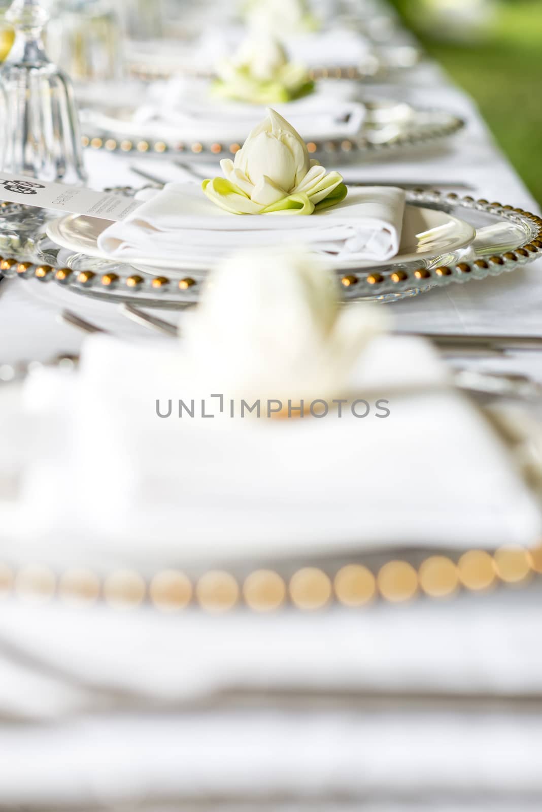 Elegance table set up with lotus flowers, selective focus.