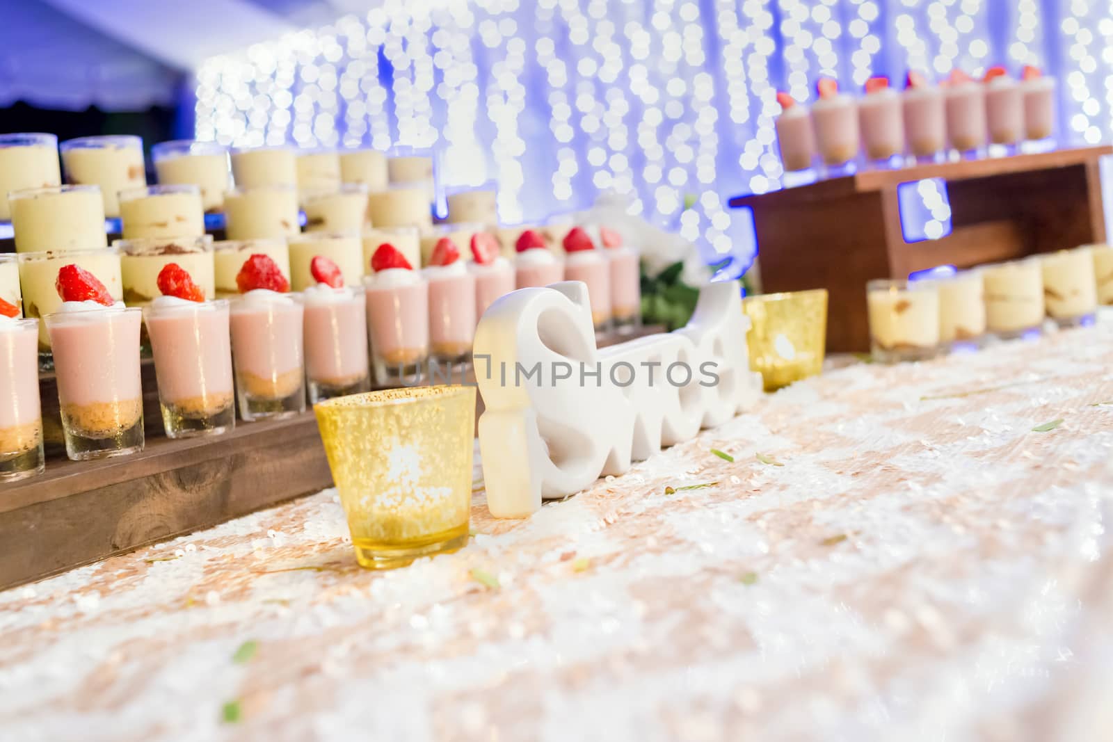 Sweet dessert on the buffet line with nice bokeh purple background, selective focus.