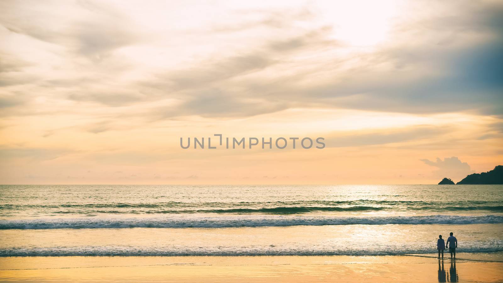 Couples on wide beaches at romantic sunset time.