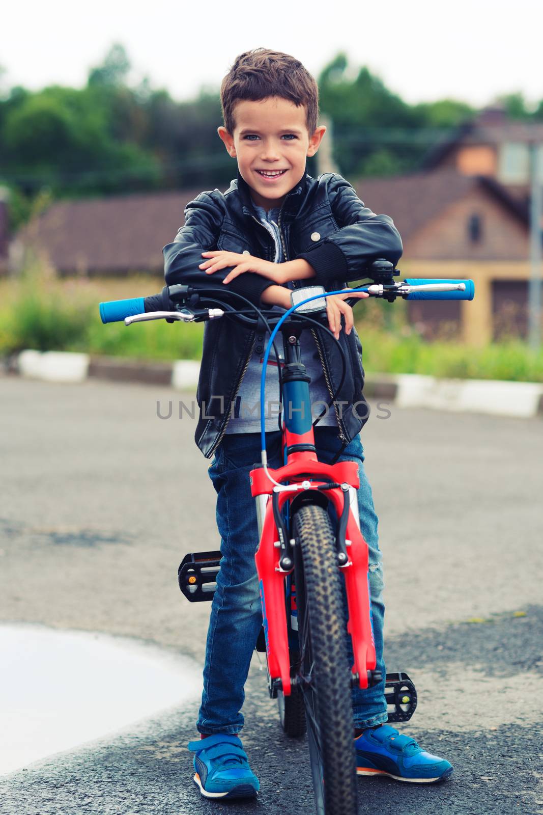 Cute boy riding bike in a city