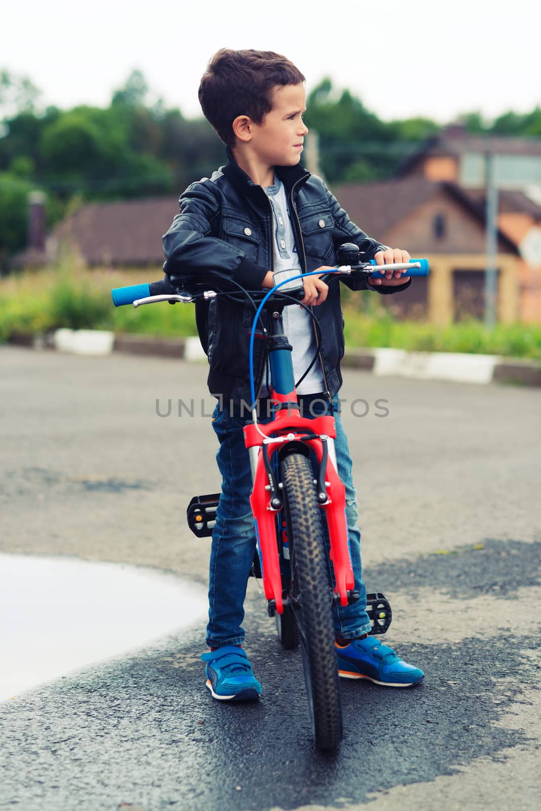 Cute boy riding bike in a city