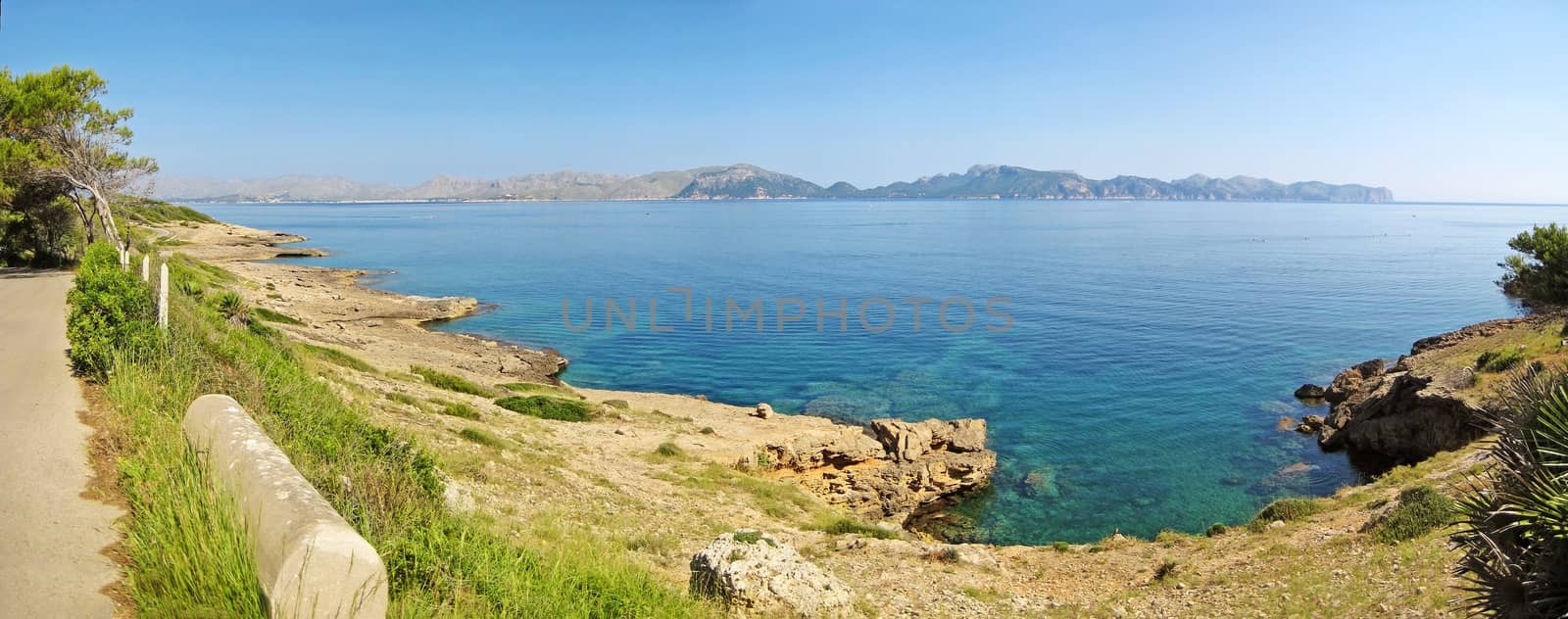 Bay of Pollenca, view from peninsula Victoria towards peninsula Formentor - clear turquoise water of mediterranean sea in front