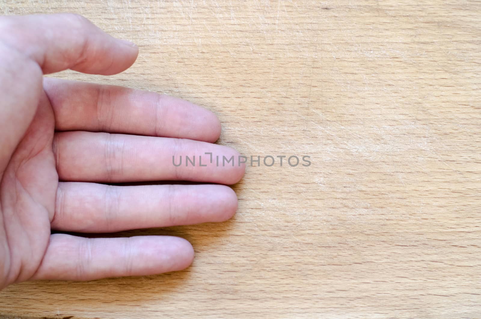 Human hand over wooden background and place for text