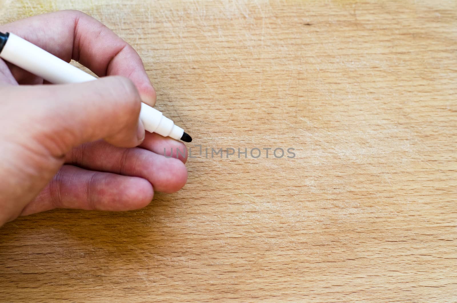 Human hand over wooden background and place for text