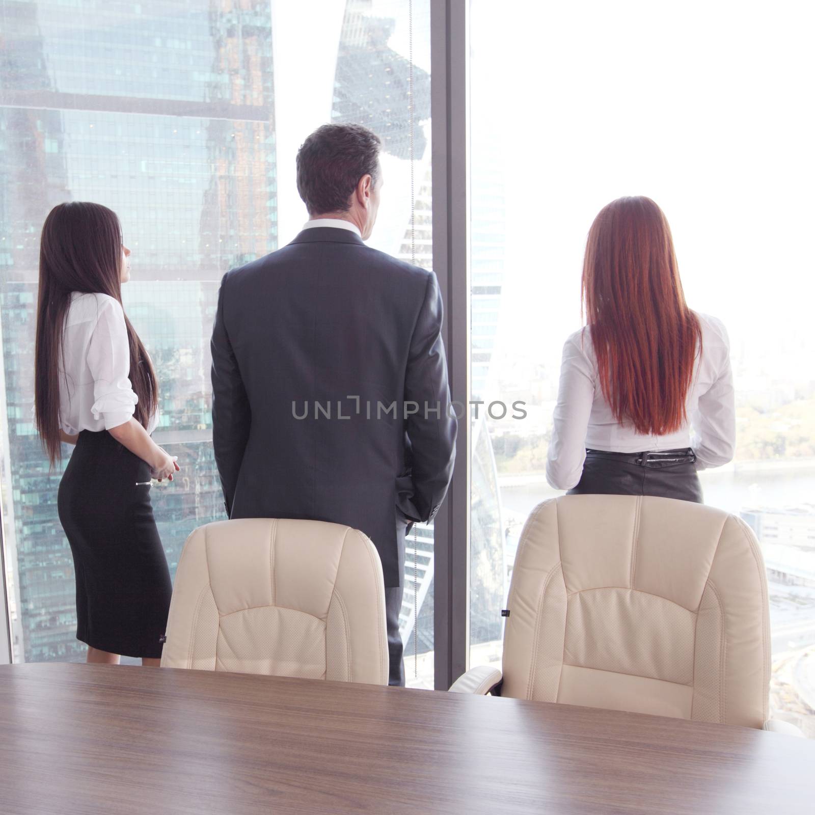 Rear view of business people looking at window