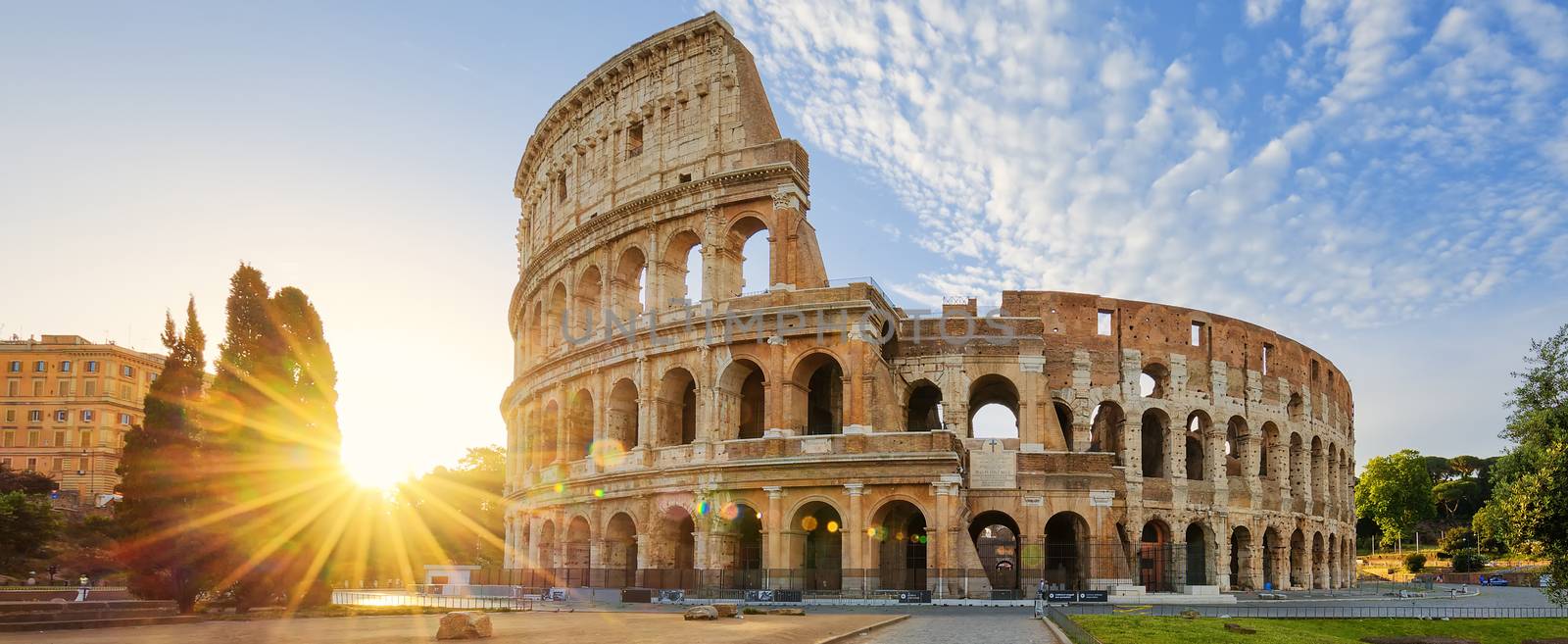 Panoramic view of Colosseum in Rome and morning sun, Italy, Europe.