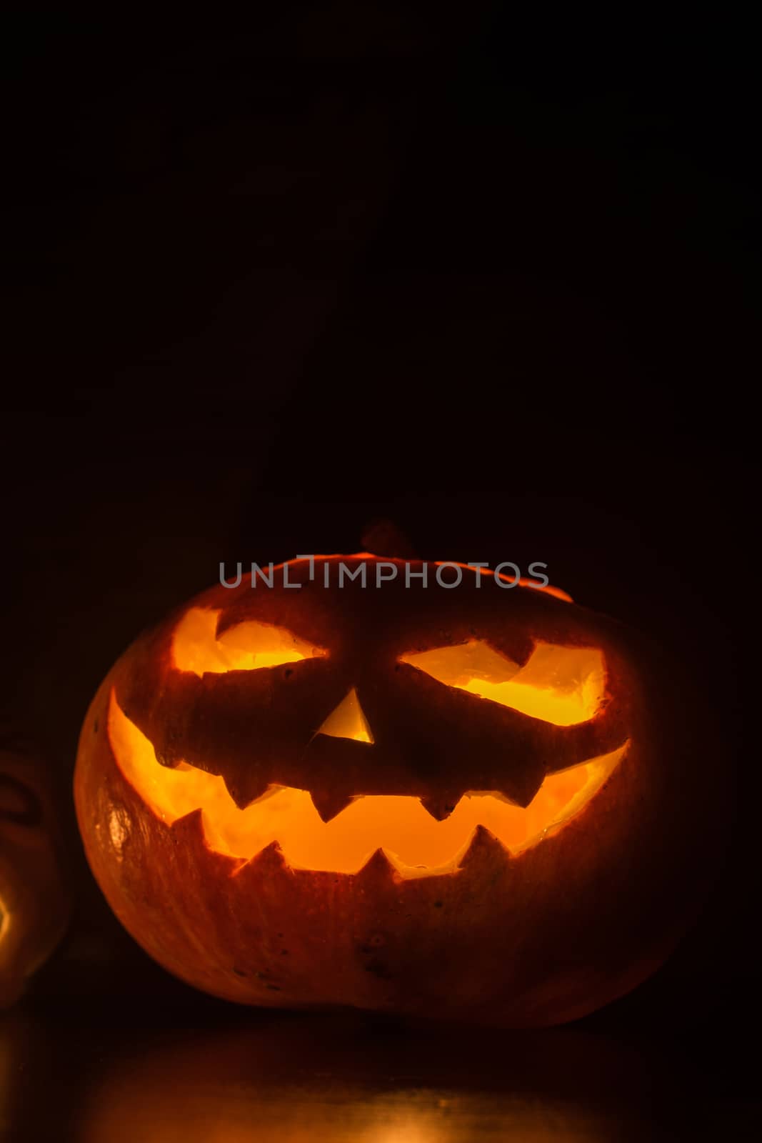 Halloween pumpkin with scary face on black backgound