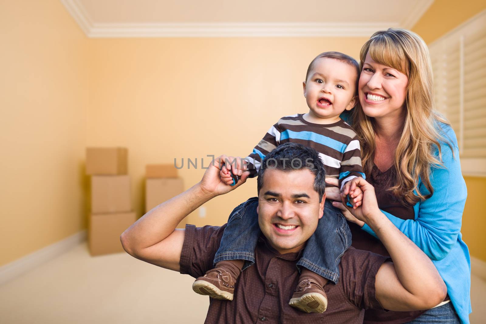Young Mixed Race Family In Room With Moving Boxes by Feverpitched