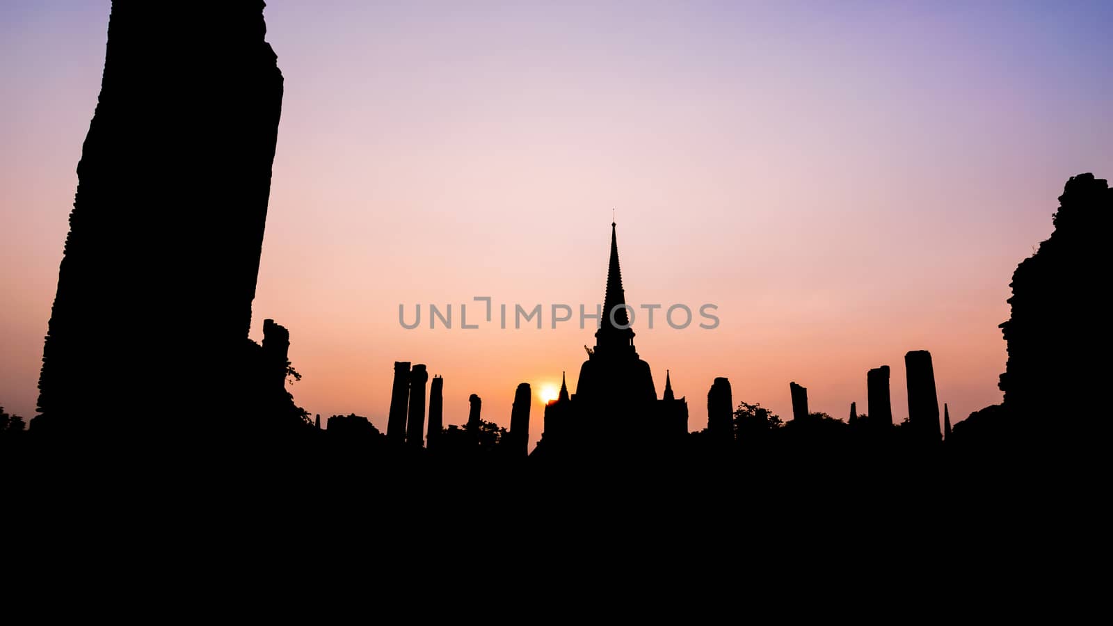Silhouette for background, Ancient ruins and pagoda of Wat Phra Si Sanphet old temple famous attractions during sunset at Phra Nakhon Si Ayutthaya Historical Park, Thailand, 16:9 wide screen