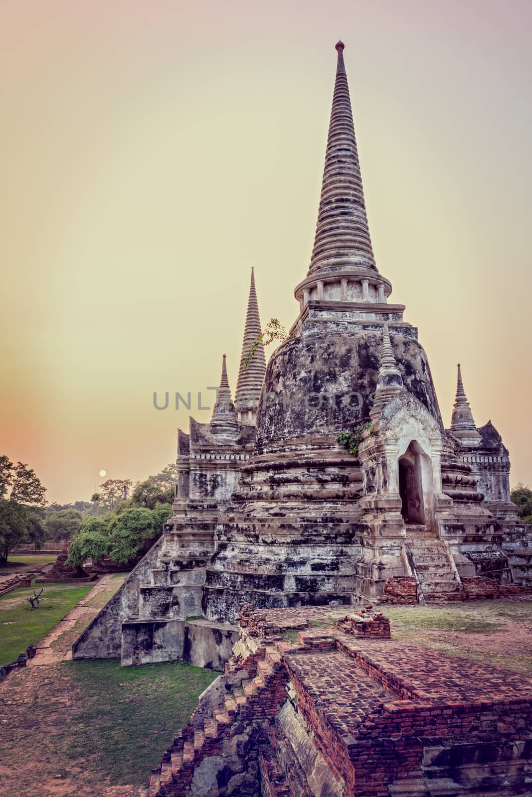 Vintage style add texture effect, ancient ruins and pagoda of Wat Phra Si Sanphet old temple famous attractions during sunset at Phra Nakhon Si Ayutthaya Historical Park, Ayutthaya Province, Thailand