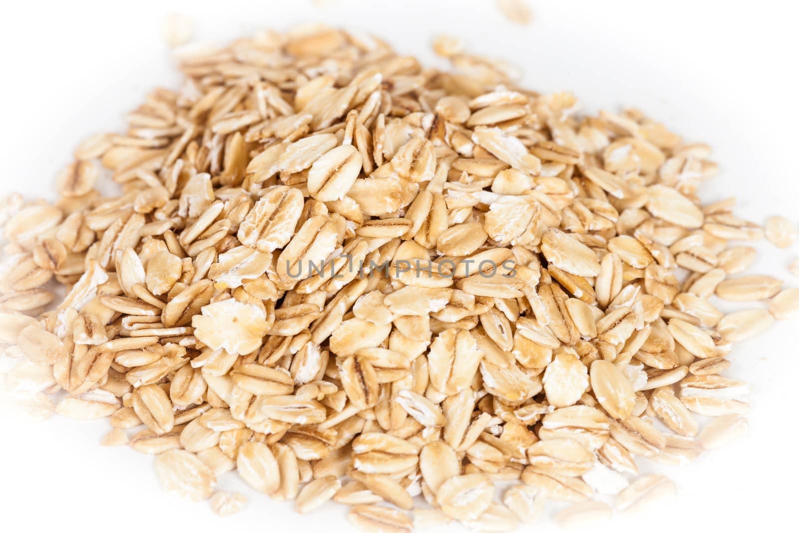 Oats flakes pile on white background