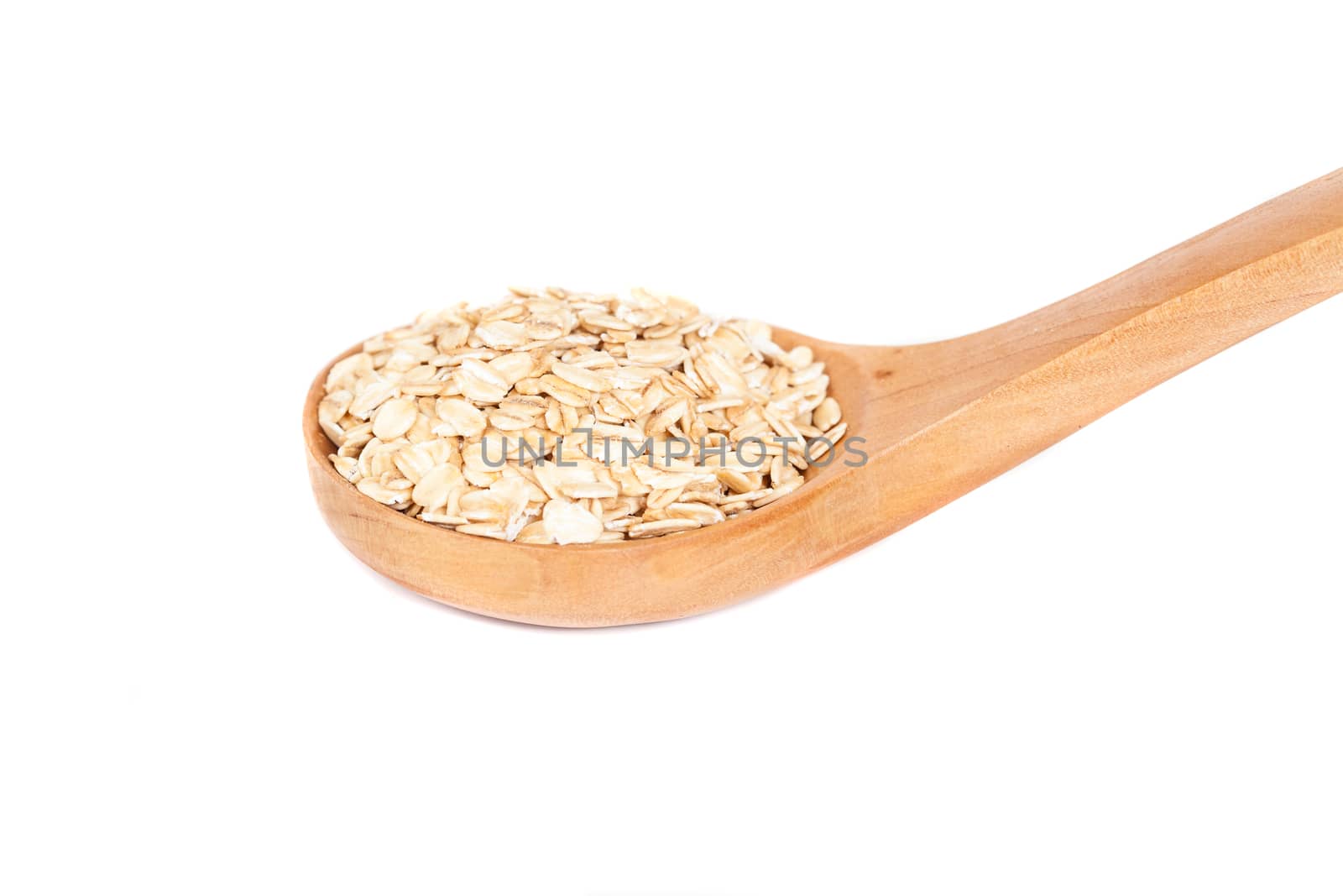 Oats flakes pile in wood spoon on white background by amnarj2006