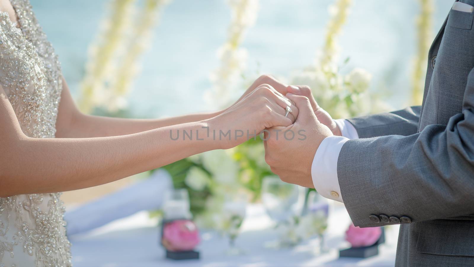 Man and Woman holding hands in wedding ceremony. Hand in hand.