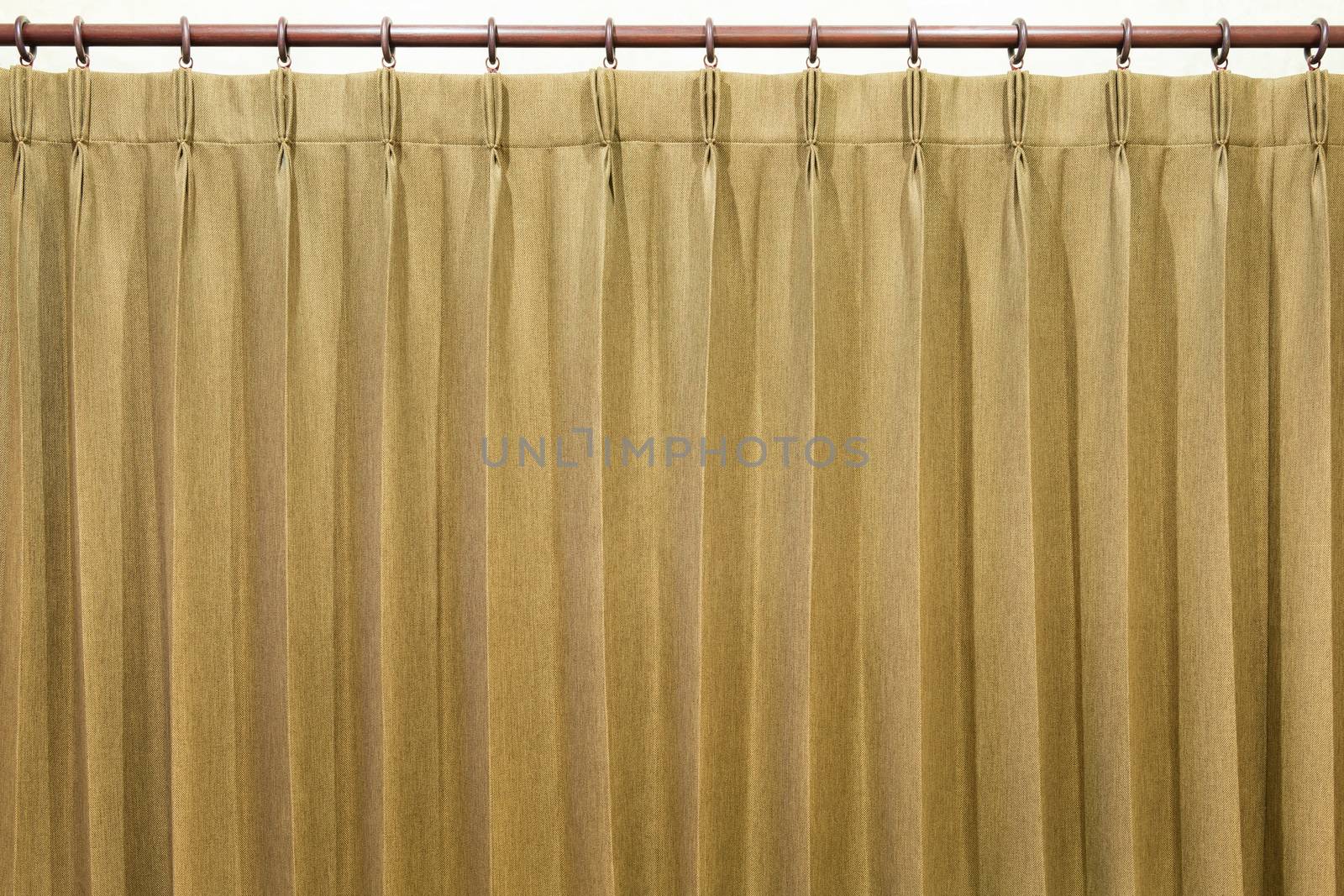 Brown curtains hang on the curtain rail.