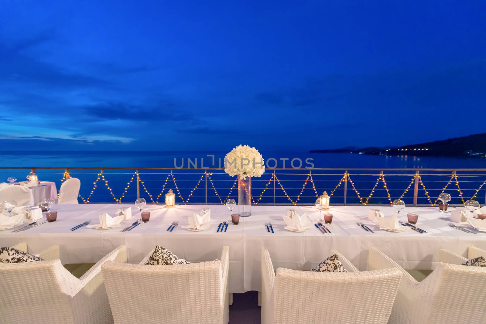 Romantic dinner setup, decoration with candle light. Selective focus. Twilight.