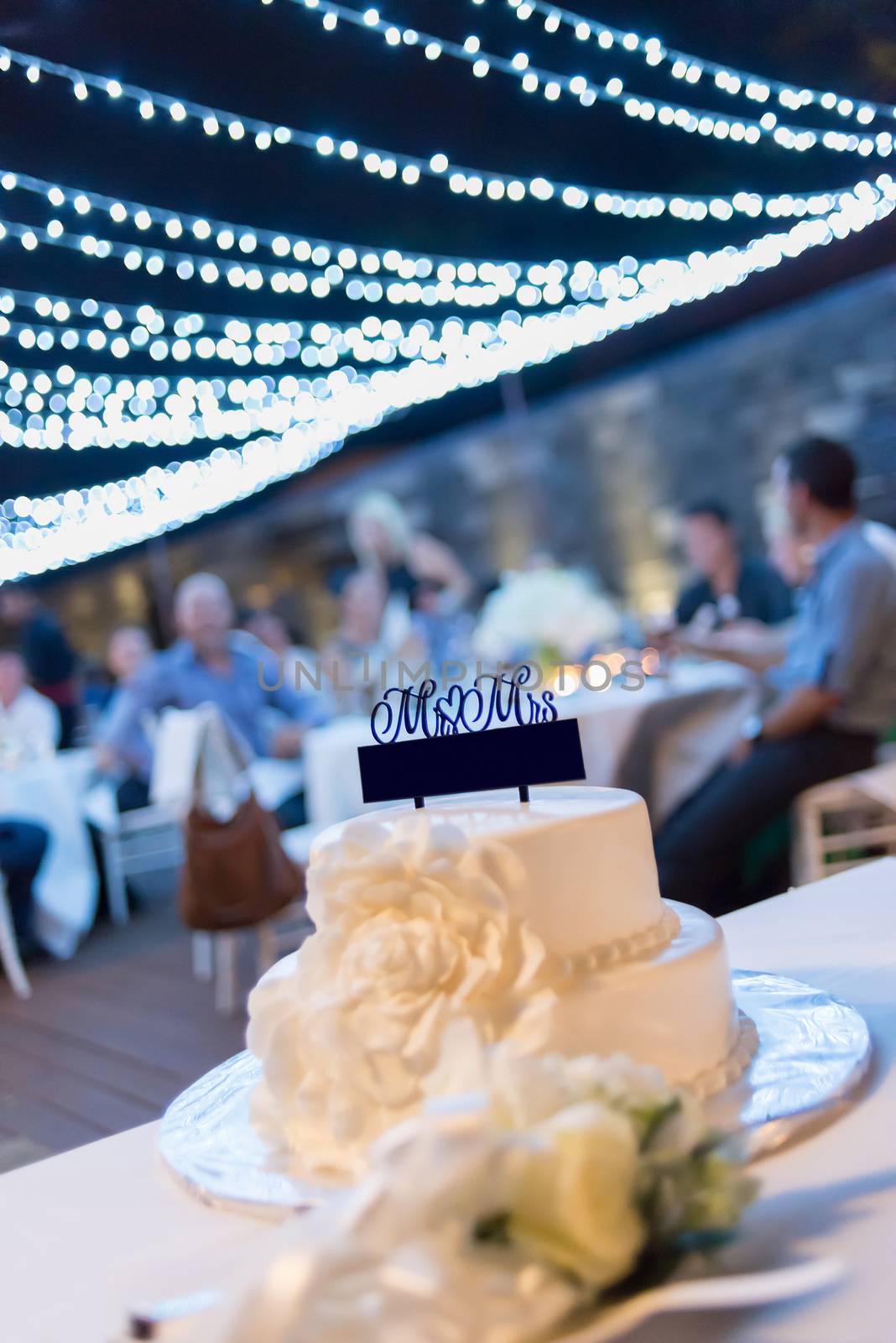 The white wedding cake, decorated with cream cakes floral. Selective focus.