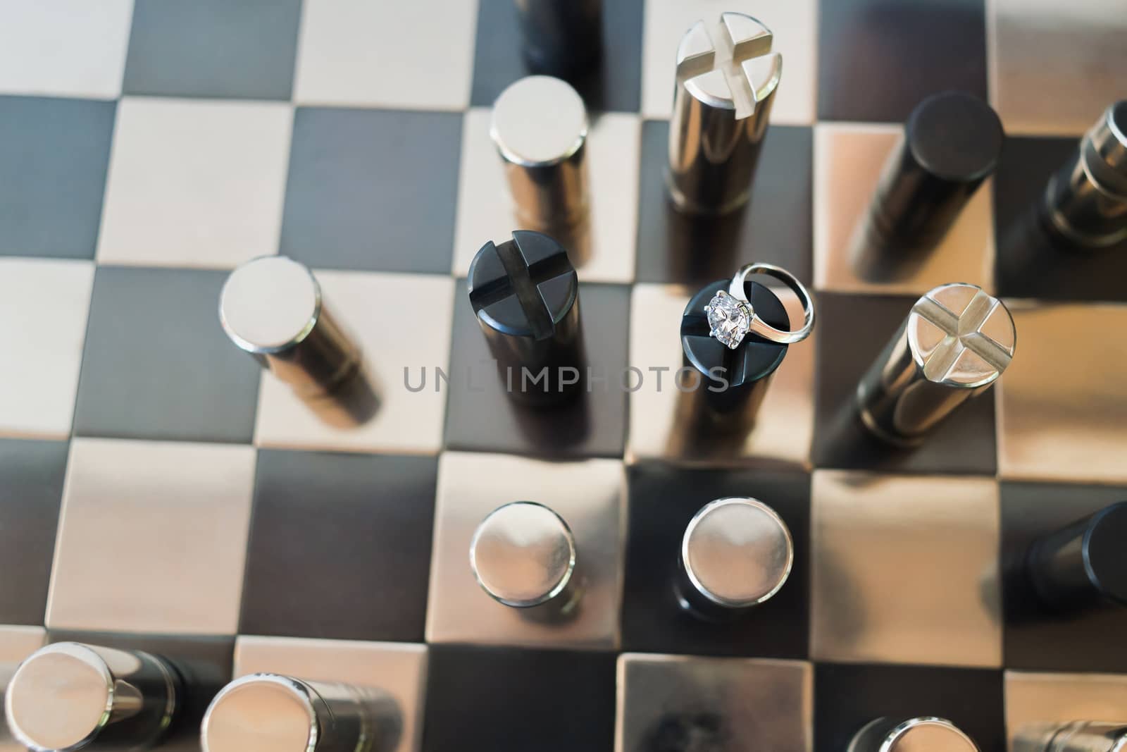 Bridal ring on black &amp; chrome metallic chess on board.