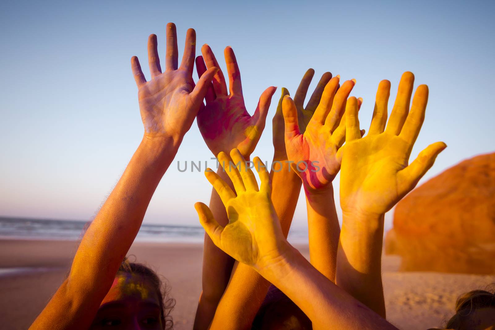 Teenagers playing with colored powder and showing her hands