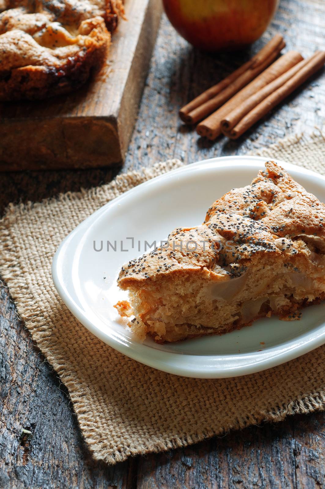 a slice of Apple pie on a wooden table