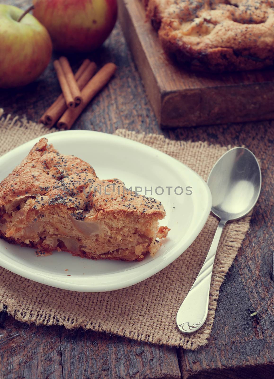 a slice of Apple pie on a wooden table
