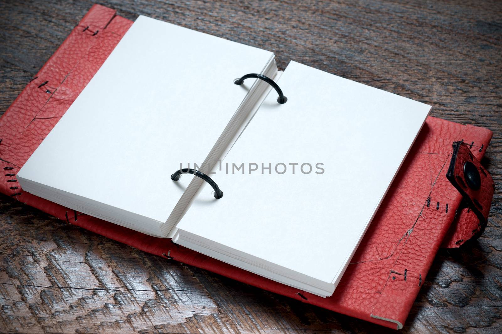 Open Red Notebook  on the wooden background