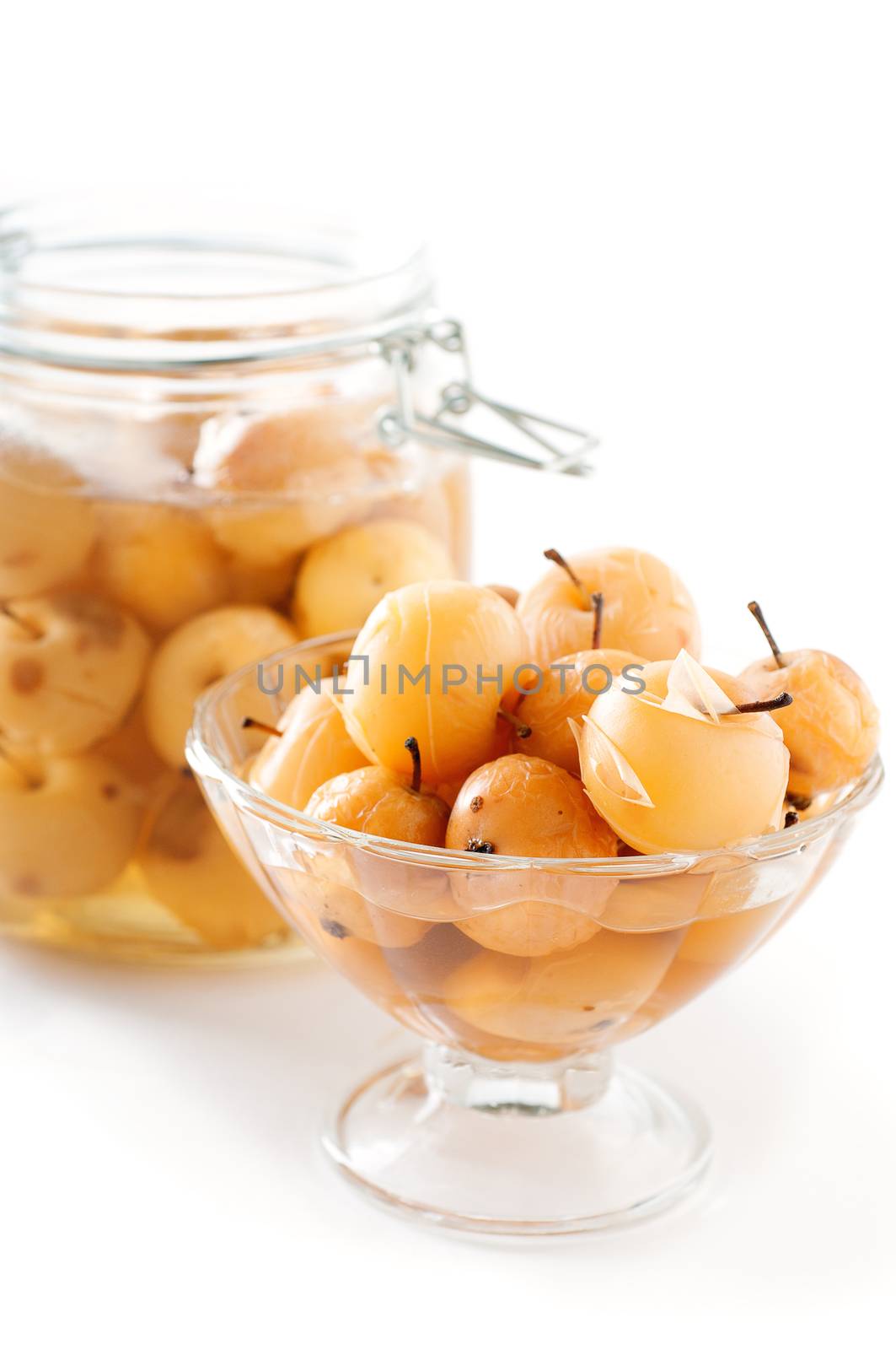 Apple compote in a glass vase and jar on white background