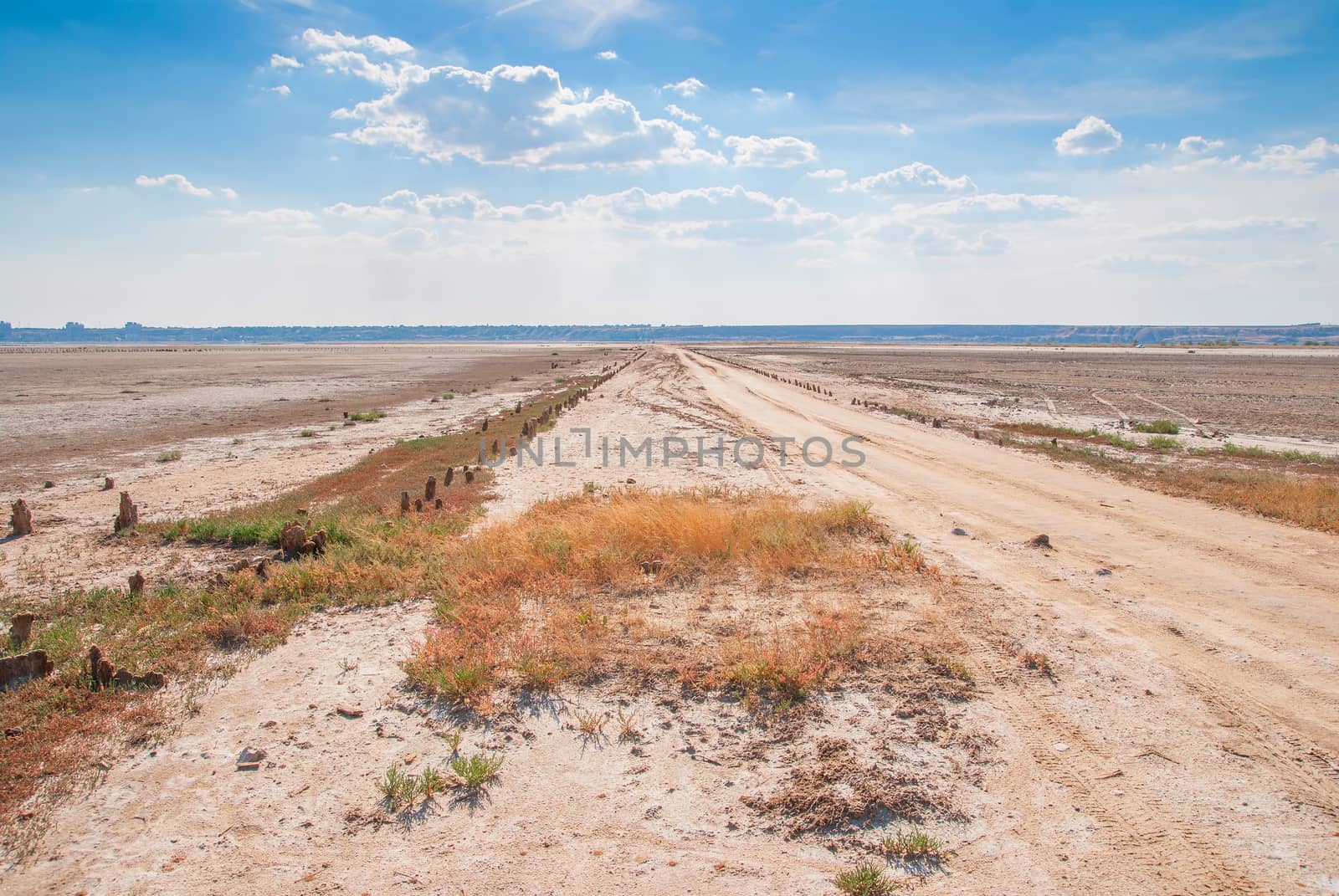 Dried salt lake shore on blue sky background