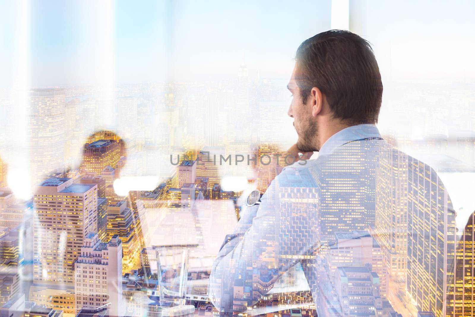 Business team meeting in conteporary corporate office. Businessman working on laptop computer. New Your city lights reflection in window. Business success concept.