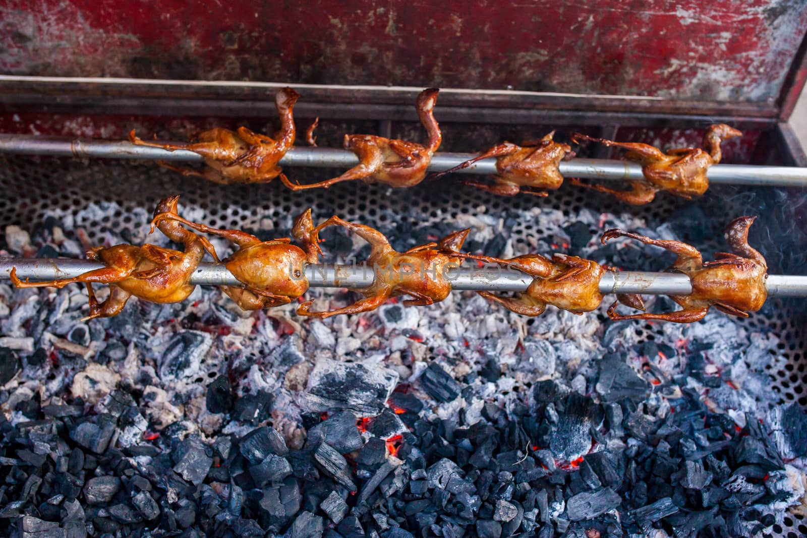 Grilled chickens on the bbq stove by nopparats