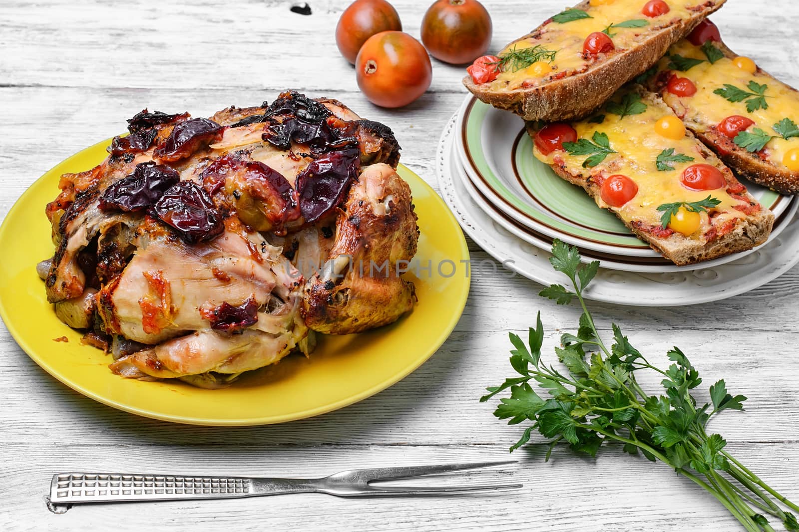 Lunch dish with roasted carcass of chicken in plum sauce